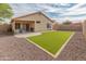 Expansive backyard with manicured synthetic lawn, gravel, and outdoor space for entertaining and leisure at 10226 N 93Rd Dr, Peoria, AZ 85345