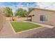 Backyard featuring low maintenance gravel landscaping, artificial turf, and a pergola at 10226 N 93Rd Dr, Peoria, AZ 85345