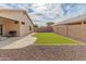 Private backyard featuring a synthetic lawn, gravel landscape, and a tranquil outdoor space at 10226 N 93Rd Dr, Peoria, AZ 85345