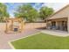 Backyard featuring artificial turf, a pergola, gravel, and an outdoor seating area at 10226 N 93Rd Dr, Peoria, AZ 85345