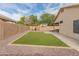 Well-maintained backyard with manicured synthetic lawn, gravel landscaping, and patio at 10226 N 93Rd Dr, Peoria, AZ 85345