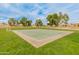 Outdoor basketball court surrounded by grassy area, perfect for recreational sports and neighborhood games at 10226 N 93Rd Dr, Peoria, AZ 85345