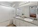 Bathroom features double sinks, granite countertop, framed mirror, and a shower-tub combination at 10226 N 93Rd Dr, Peoria, AZ 85345