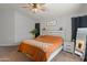 Well-lit primary bedroom with a ceiling fan, neutral paint, and stylish decor creates a calm space at 10226 N 93Rd Dr, Peoria, AZ 85345