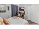 Cozy bedroom with a leather chair, flatscreen TV, and a window with light-blocking curtains at 10226 N 93Rd Dr, Peoria, AZ 85345