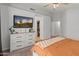 Spacious bedroom with a dresser, flatscreen TV, closet, and door to the bathroom at 10226 N 93Rd Dr, Peoria, AZ 85345