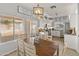 Bright dining area with lots of windows, a large wooden table, and a view of the backyard at 10226 N 93Rd Dr, Peoria, AZ 85345