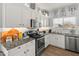 Well-lit kitchen features stainless appliances and white cabinets with modern hardware at 10226 N 93Rd Dr, Peoria, AZ 85345