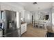 Kitchen featuring stainless steel refrigerator, granite counters, and bright dining area at 10226 N 93Rd Dr, Peoria, AZ 85345