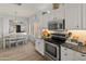 Open kitchen and dining area with stainless steel appliances and wood look flooring at 10226 N 93Rd Dr, Peoria, AZ 85345