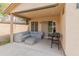 Covered patio with a cozy seating area and a grill, perfect for outdoor entertaining and relaxation at 10226 N 93Rd Dr, Peoria, AZ 85345