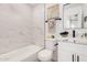 Updated bathroom with stylish vanity, framed mirror, and tub/shower combo with elegant marble tile surround at 11025 E Cholla Rd, Mesa, AZ 85207