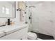 Modern bathroom featuring a sleek vanity, glass-enclosed shower, matte black fixtures and marble tile walls at 11025 E Cholla Rd, Mesa, AZ 85207