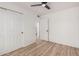 Bedroom features wood-look floors, ample closet space, and neutral paint palette at 11025 E Cholla Rd, Mesa, AZ 85207