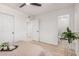Bright bedroom with wood-look flooring, a ceiling fan and an ensuite bathroom with glass enclosed shower at 11025 E Cholla Rd, Mesa, AZ 85207
