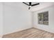 Bright bedroom featuring modern ceiling fan, wood-look flooring and window offering natural light at 11025 E Cholla Rd, Mesa, AZ 85207