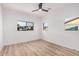 Bright bedroom with two windows and wood-look flooring providing ample natural light at 11025 E Cholla Rd, Mesa, AZ 85207