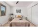 Comfortable bedroom features a ceiling fan, stylish decor, a window with natural light, and wood-look floors at 11025 E Cholla Rd, Mesa, AZ 85207