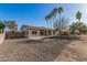 Charming single-story home with gravel landscaping, concrete driveway and palm tree accents at 11025 E Cholla Rd, Mesa, AZ 85207