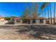 Charming single-story home with a well-kept front yard and a gravel driveway at 11025 E Cholla Rd, Mesa, AZ 85207