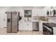 Well-lit kitchen features stainless steel appliances, white cabinets, and modern fixtures at 11025 E Cholla Rd, Mesa, AZ 85207