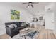 Inviting living room open to kitchen features a modern ceiling fan and stylish decor at 11025 E Cholla Rd, Mesa, AZ 85207