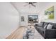 Cozy living room filled with natural light has a door and comfortable couch at 11025 E Cholla Rd, Mesa, AZ 85207