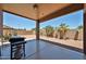 Covered backyard patio with built-in grill, and desert landscaping at 11038 W Oraibi Dr, Peoria, AZ 85373