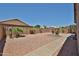 Large, enclosed backyard featuring desert landscaping and a walking path at 11038 W Oraibi Dr, Peoria, AZ 85373