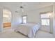 Bright bedroom with an ensuite bathroom, neutral walls, and ample sunlight from windows at 11038 W Oraibi Dr, Peoria, AZ 85373