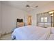 Bright bedroom featuring a ceiling fan and a closet with sliding mirror doors at 11038 W Oraibi Dr, Peoria, AZ 85373