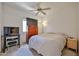 Bedroom with a ceiling fan, TV on a dresser, and a cozy layout at 11038 W Oraibi Dr, Peoria, AZ 85373