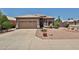 Charming single-story home features a desert landscaped front yard with a two car garage at 11038 W Oraibi Dr, Peoria, AZ 85373