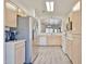 Bright kitchen with modern appliances and wood cabinets, open to living area at 11038 W Oraibi Dr, Peoria, AZ 85373