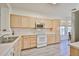 Bright kitchen with wood cabinets, modern appliances, and a window with a view at 11038 W Oraibi Dr, Peoria, AZ 85373