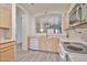 Bright kitchen with wood cabinets, stainless appliances, and pass through to living space at 11038 W Oraibi Dr, Peoria, AZ 85373