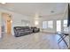 Spacious living room with ample seating, ceiling fan and neutral color palette at 11038 W Oraibi Dr, Peoria, AZ 85373