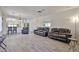 Large living room featuring modern gray floors and neutral color scheme at 11038 W Oraibi Dr, Peoria, AZ 85373