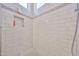 Modern tiled shower featuring stylish accent tiles and built-in niche at 11038 W Oraibi Dr, Peoria, AZ 85373