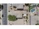 An aerial view shows the landscaped backyard with a grassy area, pool and patio with white party tent at 1162 E Ranch Ct, Gilbert, AZ 85296