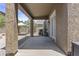 Covered back patio featuring stucco columns, outdoor lighting, and access to backyard at 1162 E Ranch Ct, Gilbert, AZ 85296