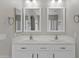 Bathroom featuring a double sink vanity with framed mirrors and plenty of cabinet space at 1162 E Ranch Ct, Gilbert, AZ 85296