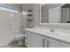 Bathroom featuring a shower-tub combo, vanity with sink, and framed mirror at 1162 E Ranch Ct, Gilbert, AZ 85296