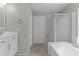 Bright bathroom with vanity sink, tile floor, walk-in shower and soaking tub is designed for relaxation at 1162 E Ranch Ct, Gilbert, AZ 85296