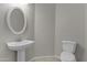 Powder room features a pedestal sink, oval mirror, and tiled floors at 1162 E Ranch Ct, Gilbert, AZ 85296
