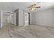 Large carpeted primary bedroom featuring a ceiling fan and ensuite bath at 1162 E Ranch Ct, Gilbert, AZ 85296