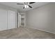 Spacious bedroom features neutral walls, ceiling fan, and closet with sliding doors at 1162 E Ranch Ct, Gilbert, AZ 85296