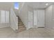 Bright foyer featuring tile flooring, a staircase, and doors with white trim, creating an inviting entry space at 1162 E Ranch Ct, Gilbert, AZ 85296