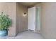 Covered front entrance highlighting the white front door, side window, and adjacent plant for added appeal at 1162 E Ranch Ct, Gilbert, AZ 85296