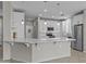 Bright white kitchen with stainless appliances, a large island and barstool seating at 1162 E Ranch Ct, Gilbert, AZ 85296